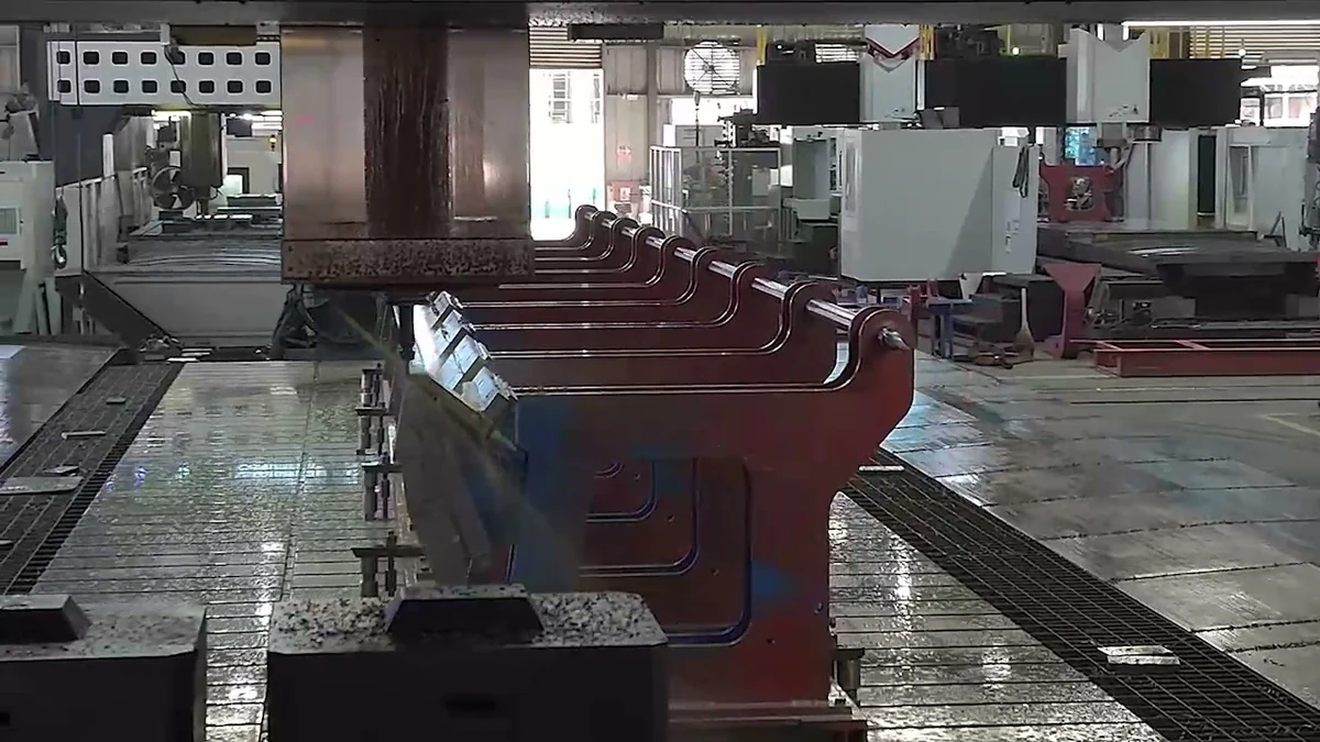 Real factory workshop showing large machine components arranged for machining