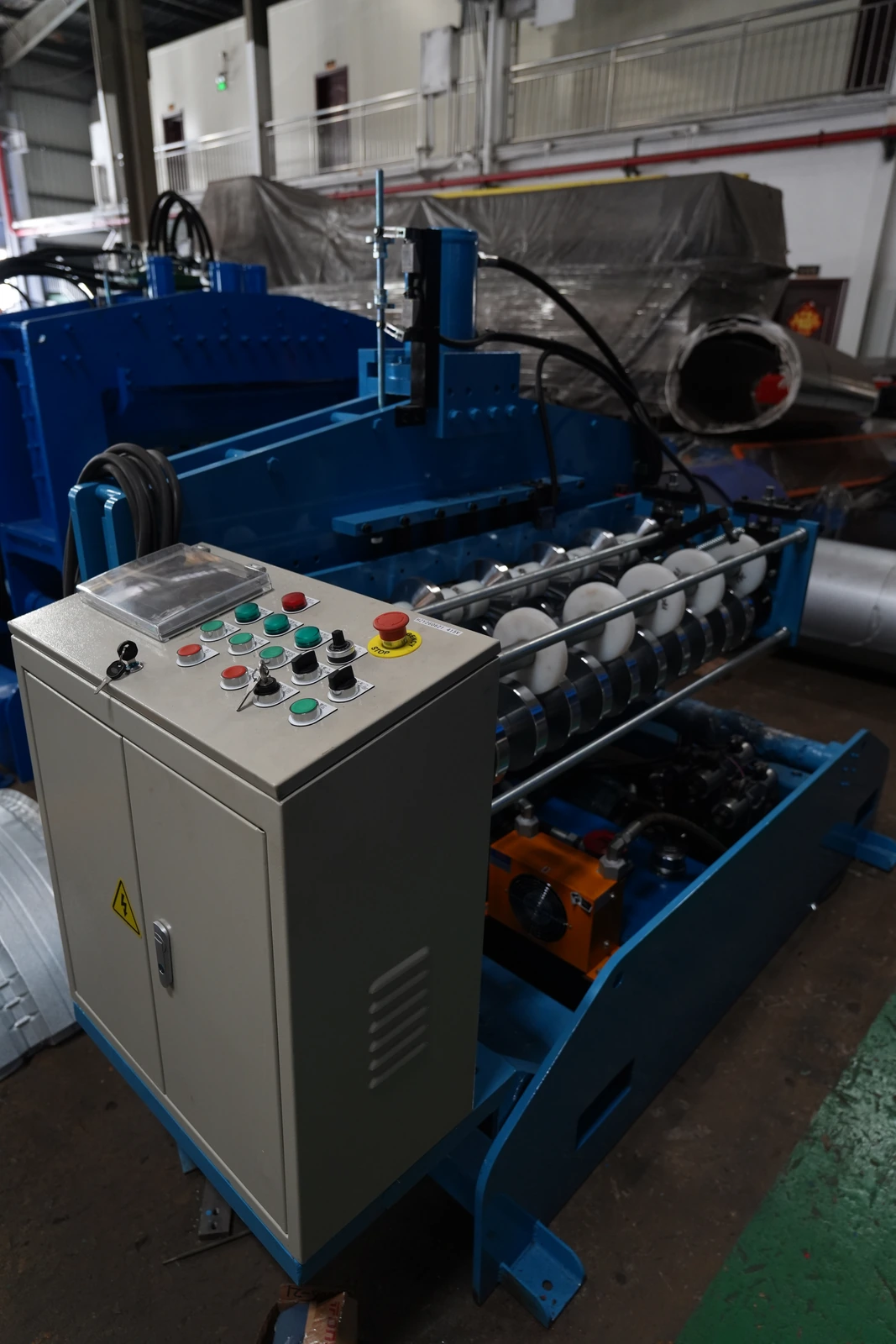 Operator control cabinet beside roll forming and cutting equipment in our Xiamen production base