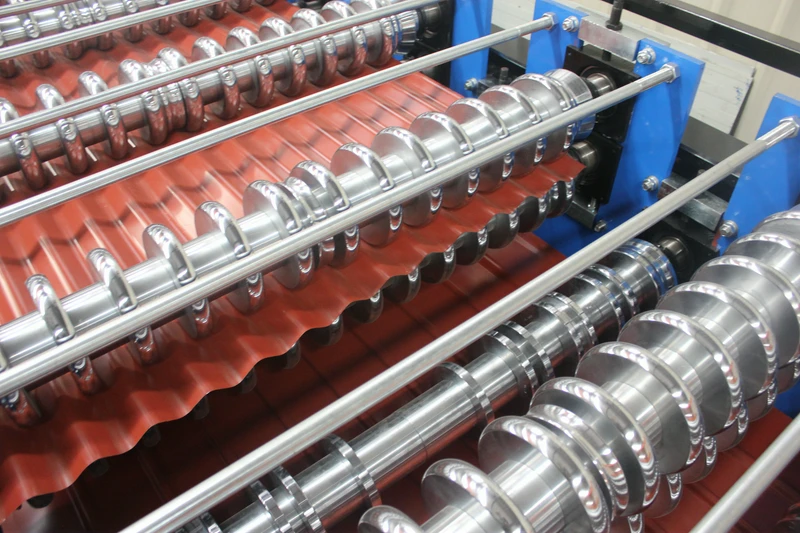 Close-up of two roll-tooling levels forming a red roof sheet on our Xiamen production base's published double-layer line